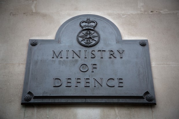 Outside the building of the Ministry of Defence, focusing on the plaque outside saying the name of the department